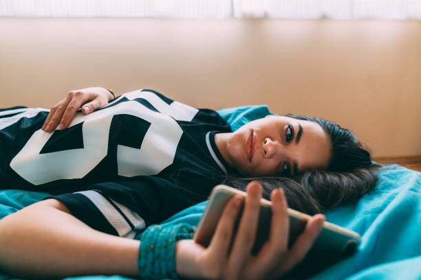 istock Woman in bed using mobile phone 1218981131