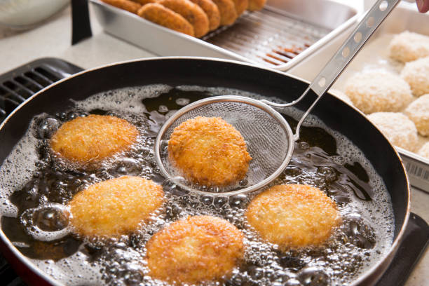 Croquette cooking Croquette cooking Deep Frying stock pictures, royalty-free photos & images