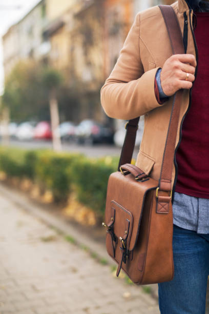 istock Close up of a briefcase on businessman shoulder. 1218981392
