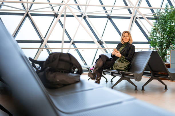 istock Woman using a mobile phone at the airport 1218983000