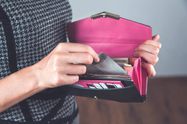 istock woman hand holding money with wallet 1218983265