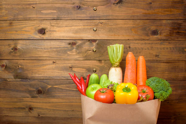 istock vegetables in grocery bag on wood background 1218983531