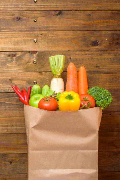 istock vegetables in grocery bag on wood background 1218983532