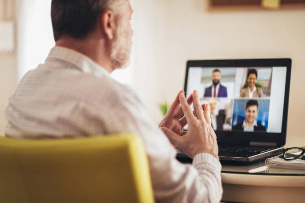 istock Man working from home having online group videoconference on laptop 1218983960