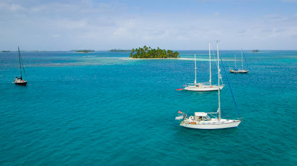yachts anchoring in the San Blas Islands, Panama sailing yachts at anchor in the turquoise colored waters of the San Blas Islands, Kuna Yala, Panama kuna yala stock pictures, royalty-free photos & images