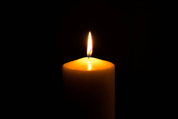 istock Flame candle isolated on black background. 1218985181