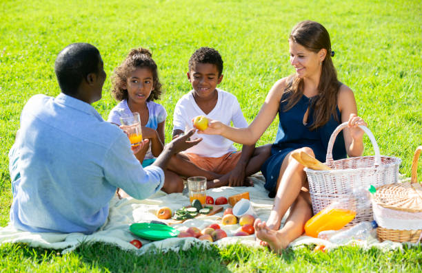 istock Couple with children at picnic 1218985555