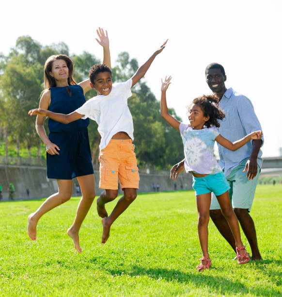 istock Happy kids with parents jumping 1218985562