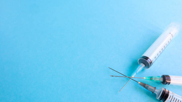 istock Three medical disposable plastic empty syringes with needles of different sizes and volumes. Vaccination concept, quarantine, self isolation, protection against coronavirus, medicine. copy space 1218985776