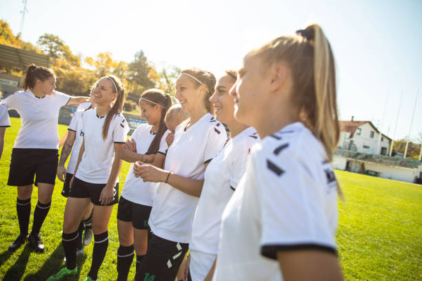 istock Female soccer team having fun after practice on soccer field 1218986135