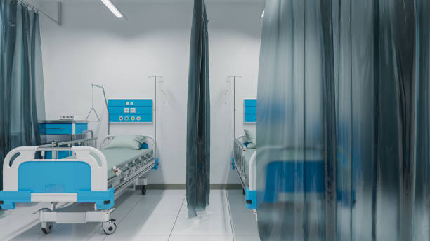 istock Empty Patient Beds Inside an Illuminated Hospital Ward 1218986845