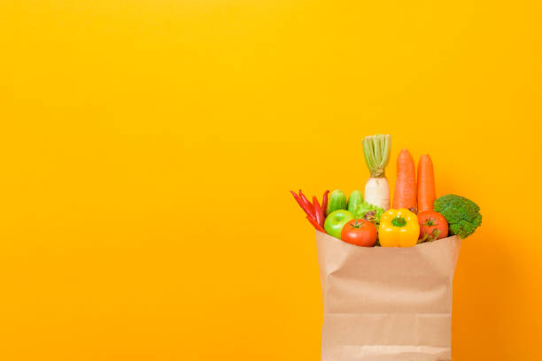 istock vegetables in grocery bag on yellow background 1218987464
