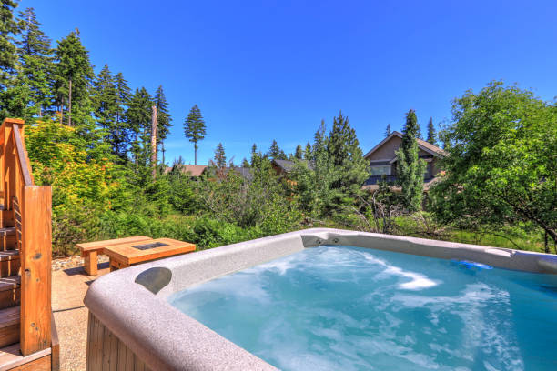istock Small but open to greenery back yard space with fire and hot tub and wooden deck 1218987906