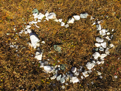 flatlay of white pebble stones shaped as a heart