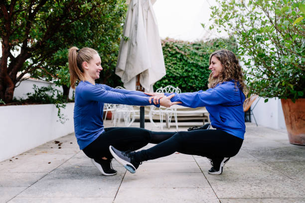 istock Two young women doing exercise together on a terrace 1218989966