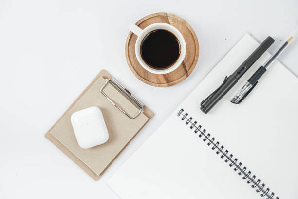 istock White office desk table with blank notebook, computer keyboard and other office supplies. Top view with copy space, flat lay. 1218991228