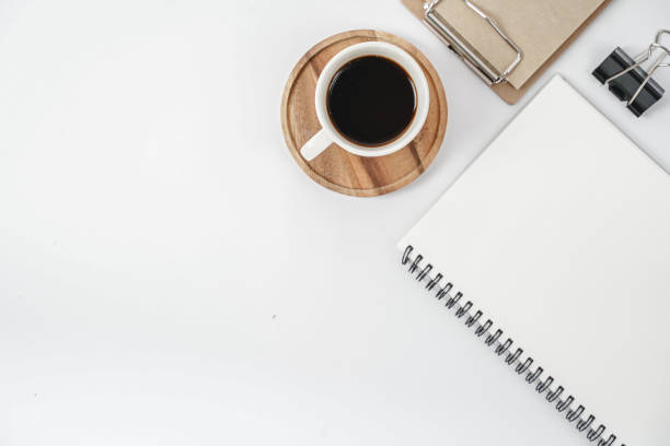 istock White office desk table with blank notebook, computer keyboard and other office supplies. Top view with copy space, flat lay. 1218991264