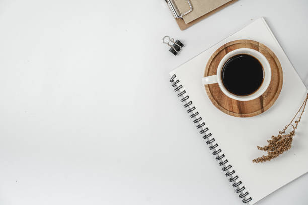 istock White office desk table with blank notebook, computer keyboard and other office supplies. Top view with copy space, flat lay. 1218991265