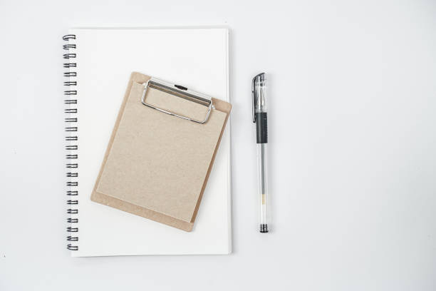 istock White office desk table with blank notebook, computer keyboard and other office supplies. Top view with copy space, flat lay. 1218991282