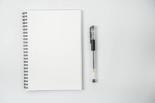 istock White office desk table with blank notebook, computer keyboard and other office supplies. Top view with copy space, flat lay. 1218991286