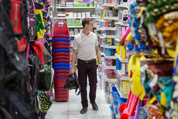 istock Young father in a children's store. 1218991499