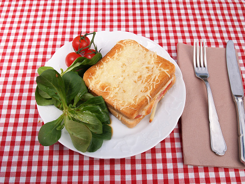 Croque-monsieur a traditional French bread sandwich with grated cheese and ham grilled