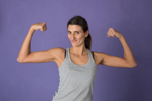 istock young woman doing weights at home 1218991796