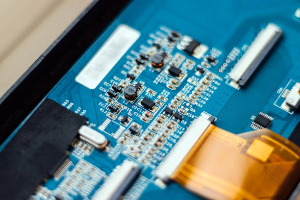 istock Part of a blue computer motherboard with same capacitors background. Selective focus. Closeup view 1218992946