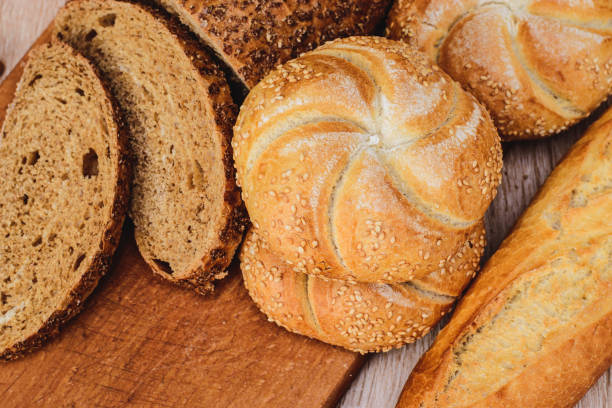 istock Crisp bread with buns. French baguettes. Fresh crispbread. Bread background. Different breed  on wooden background. 1218993363