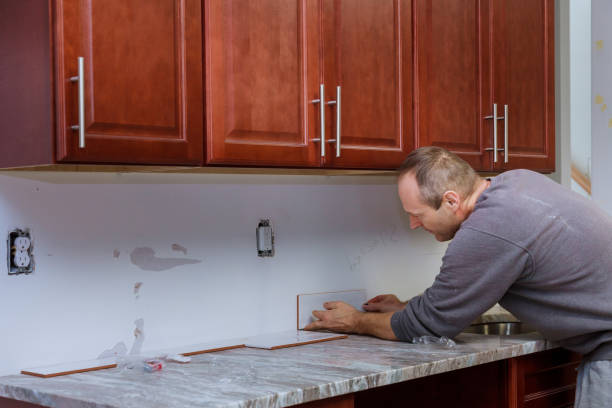 istock Tile grouting applying grout to the joint tiles for home improvements to a kitchen 1218993459