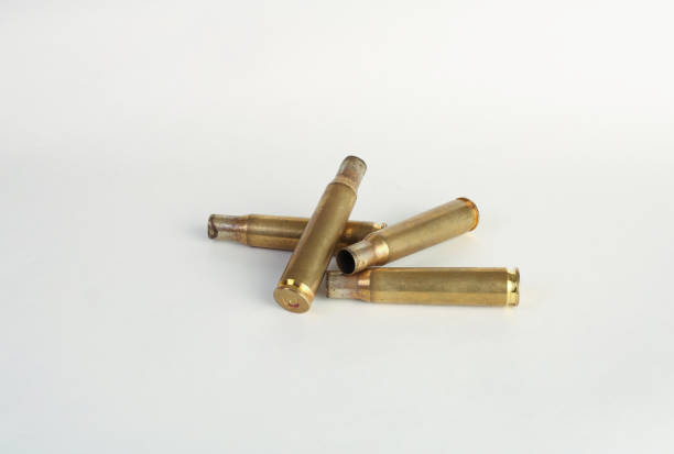 istock rifle bullet shell casings on white background 1218996591