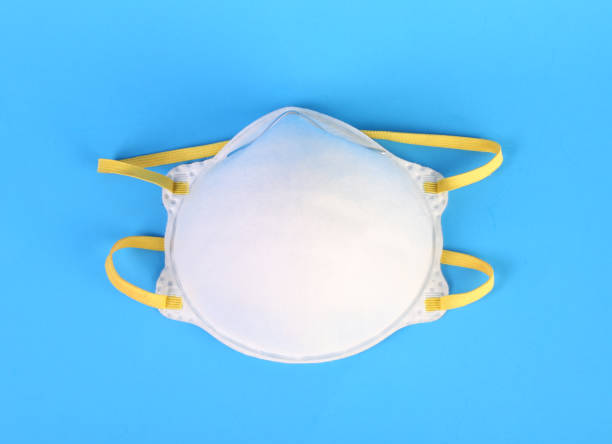 istock Medical mask on blue background 1218998154