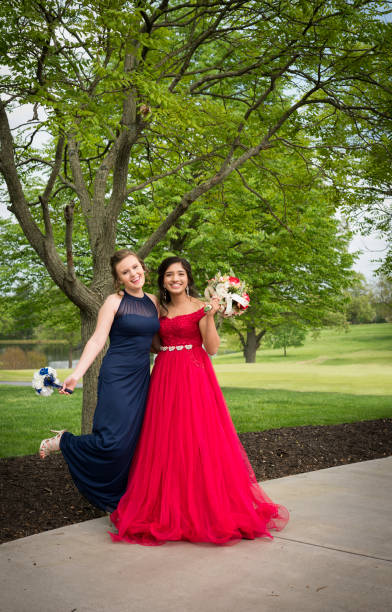 istock Best friends in formal dresses before prom 1218998753