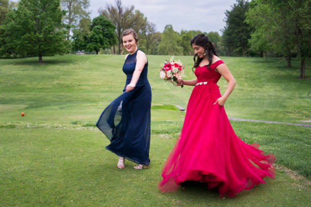 Best friends dancing on the lawn before prom