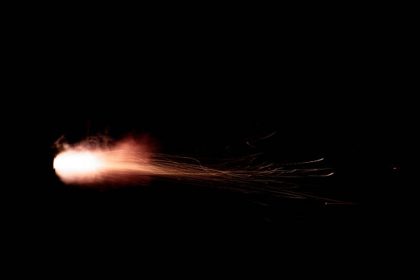 A shot from a firearm on a black background A shot from a firearm on a black background, a fiery exhaust with flying sparks, flames bursting out of the pipe shooting a weapon photos stock pictures, royalty-free photos & images
