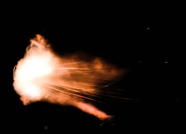 Photo of A shot from a firearm on a black background