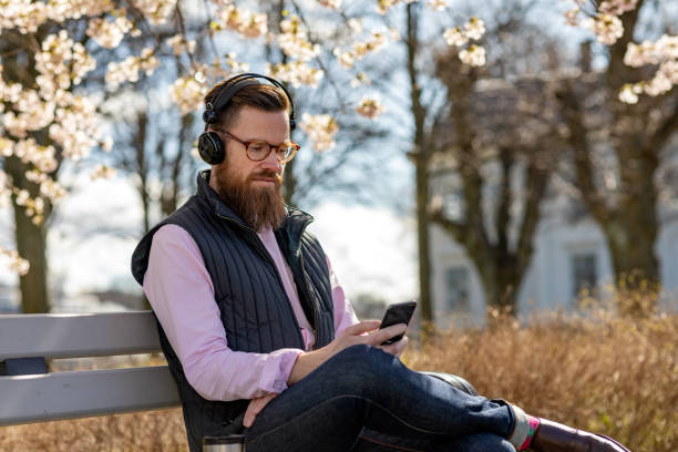 istock Man sitting by cherry blossom trees 1219002274