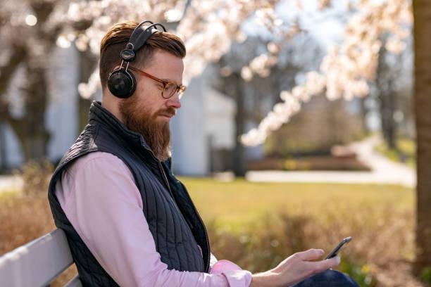 istock Man sitting by cherry blossom trees 1219002283