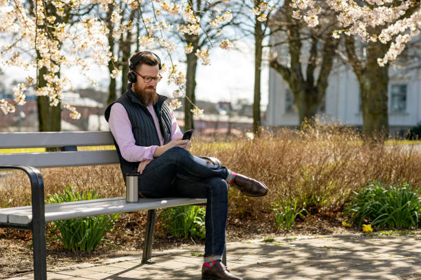 istock Man sitting by cherry blossom trees 1219002286