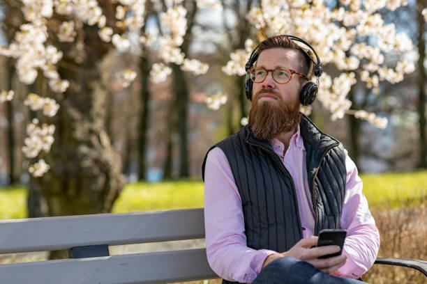 istock Man sitting by cherry blossom trees 1219002311
