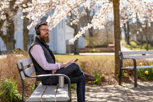 istock Man sitting by cherry blossom trees 1219002338