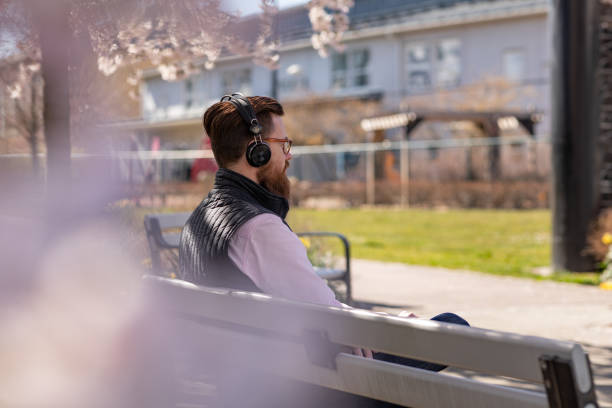 istock Man sitting by cherry blossom trees 1219002359