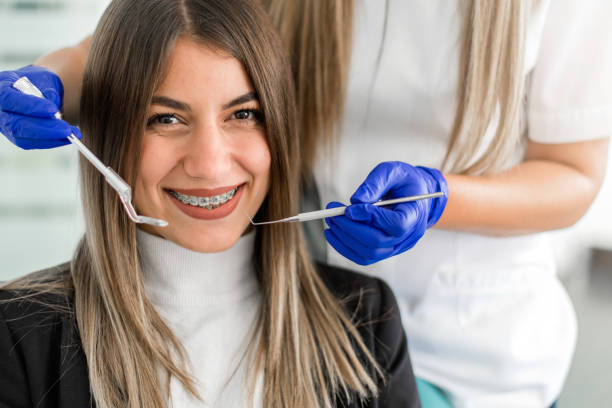 istock Young woman at the dentist braces check up 1219003533
