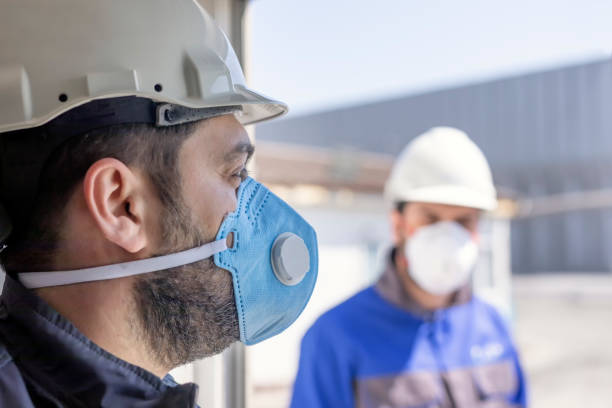 The workers are using personal protective equipments. For healthcare professionals caring for people with covid-19, the CDC recommends placing the person in an airborne infection isolation room. The workers are using personal protective equipments. For healthcare professionals caring for people with covid-19, the CDC recommends placing the person in an airborne infection isolation room. protective mask workwear stock pictures, royalty-free photos & images