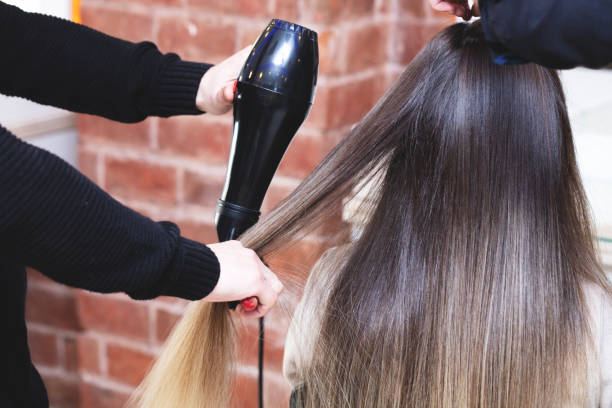 istock Stylist Drying Girl's Hair 1219005123