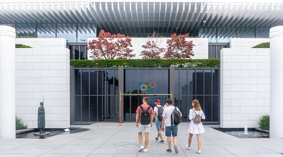 Lausanne, Switzerland - July 7, 2019: young people go to the entrance to the Museum of the Olympic Games. Popular locations in Switzerland.