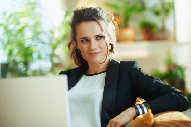 istock pensive stylish woman reading text while sitting on divan 1219007750