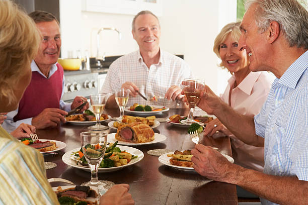 istock Friends Enjoying Lunch At Home Together 121900839