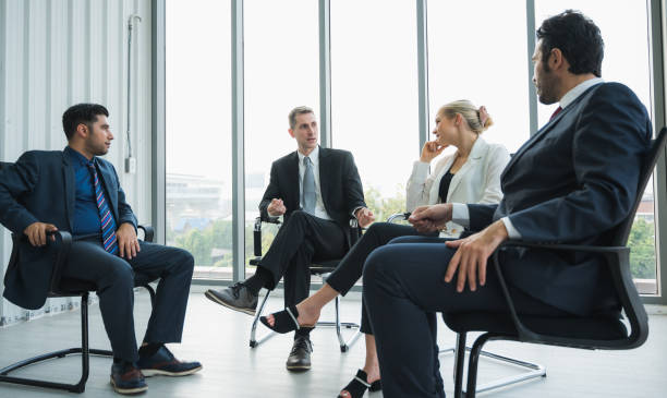 istock Business People Meeting Conference Discussion Corporate Concept in office. Team analyzing statistics financial. 1219009821