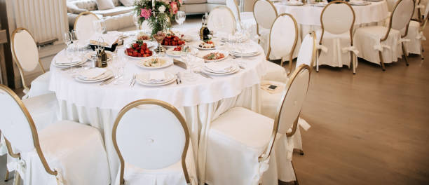 Elegant wedding reception white table arrangement, decoration with flowers and candles